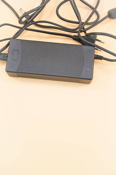 istock power supply with cables isolated on a beige desk background 1443190864