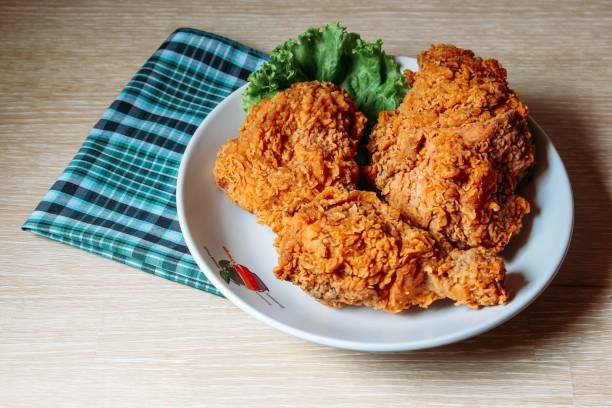 istock Crispy fried chicken and checkered kitchen towel on a wooden table 1443192346