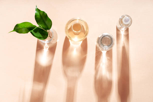 istock Cosmetic glass jars and flasks in the rays of sunlight shadow falling on the background. Cosmetic background. Flat style. 1443194955