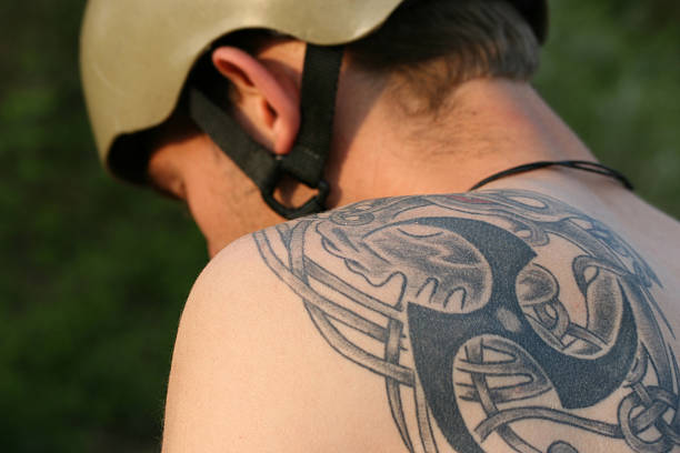 cool tattoo on the shoulder of an bmx biker shoulder tribal tattoos for men stock pictures, royalty-free photos & images