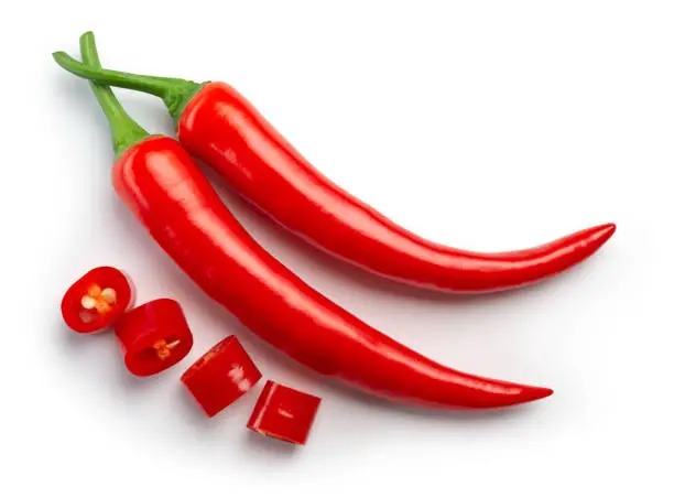 Photo of Chili pepper isolated. Chilli top view on white background. Whole and cut red hot chili peppers top. With clipping path.