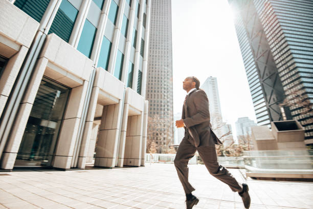 istock business man running on the city 1443198108