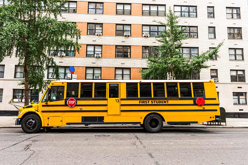 School Bus waiting in Fifth Avenue. Traditional yellow school bus. Manhattan, New York City. USA.