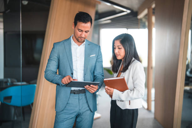 istock Asian Man and Woman Looking at Digital Tablet at Work 1443199463