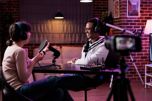 istock Man and woman recording podcast conversation on camera 1443199784
