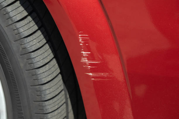 Scratching on the front of the car's wing in a car repair shop. stock photo