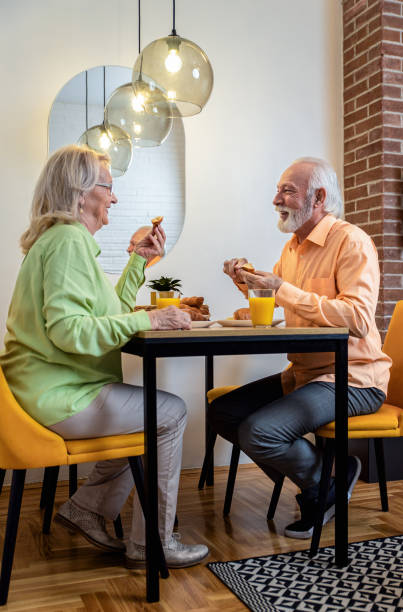 istock Senior couple eating breakfast at home. 1443201157