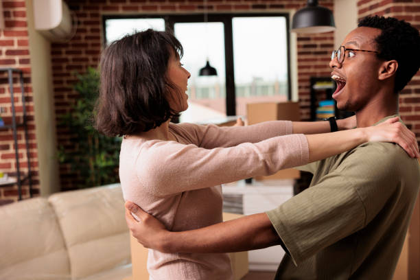 istock Positive romantic couple sharing hug after moving in together 1443201219
