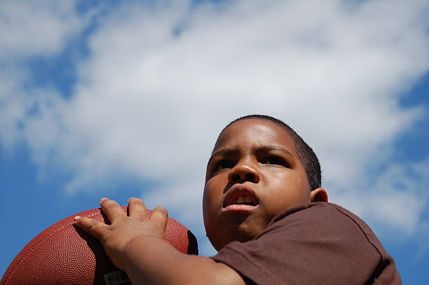 istock Boy Playing Football 144320123