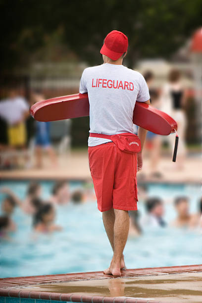 Lifeguard on duty in swimming pool stock photo