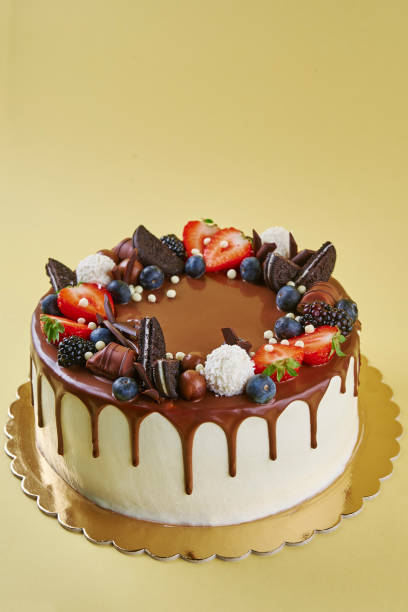 istock Cake decorated with strawberry and chocolate on yellow background 1443205563