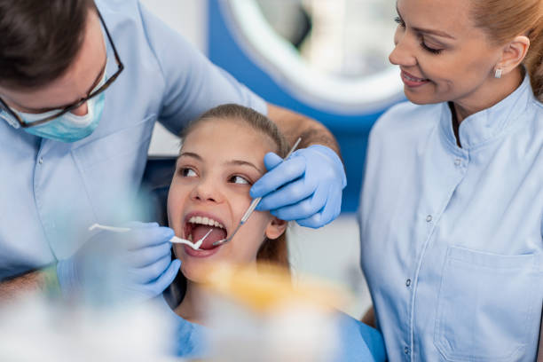 Dentist checking patient teeth stock photo