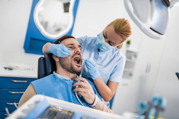 istock Woman dentist at work with patient 1443205950