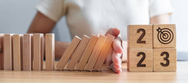 istock Hand stop falling blocks with 2023 year. Risk Management, recession, business financial, Resolution, strategy, goal, New Year planning and inflation economy concepts 1443206227
