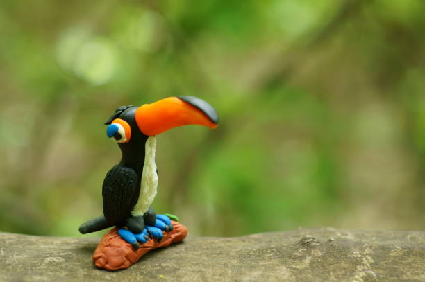 A toy toucan with an orange beak close-up. Tropical birds.