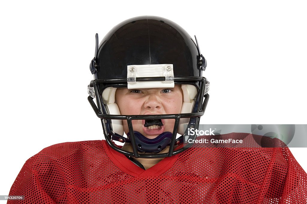 Young boy in football gear including black helmet Young football player with helmet Mouthguard Stock Photo