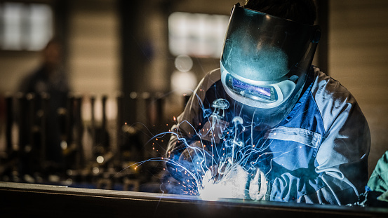 welder works in an industrial company - production of steel components