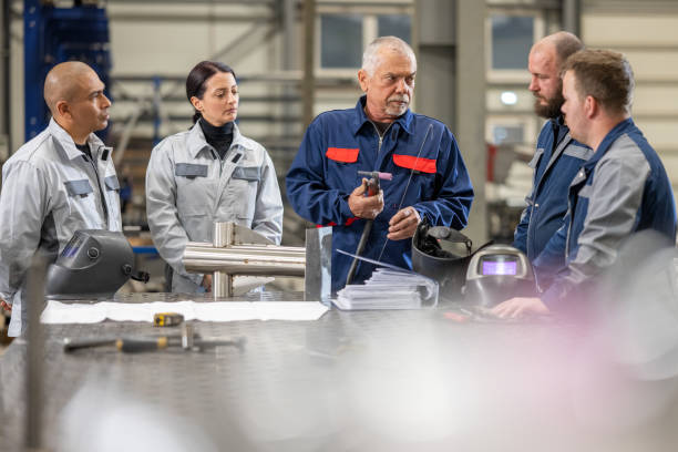 istock Workers discussing in factory 1443208388
