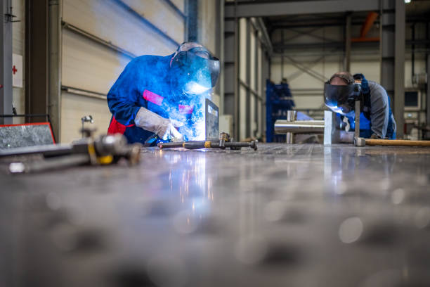 Welders working in factory