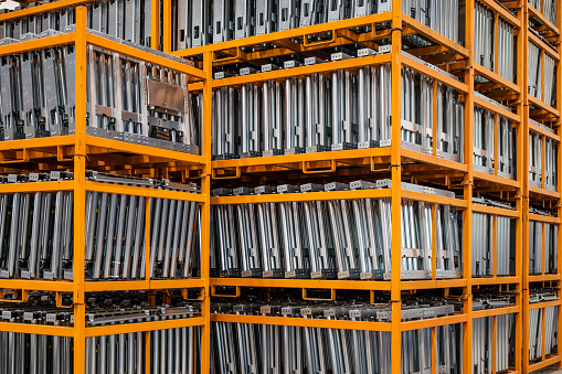 Steel rods in storage shelves in steel warehouse.