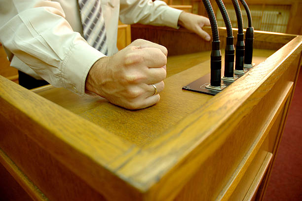 istock Man making speech with fist on lecture stand 144320953