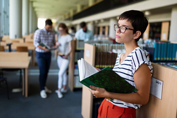 istock Happy group of students studying and working together in a college library 1443209664