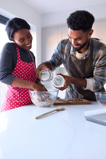 istock Couple At Home Baking Cake Together In Kitchen 1443210129