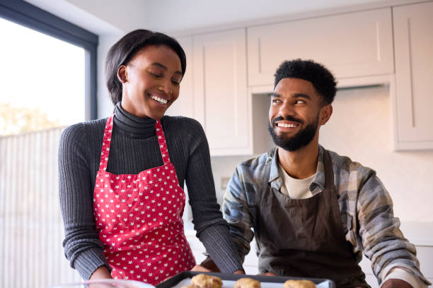 istock Couple At Home Baking Cookies Together In Kitchen 1443210320