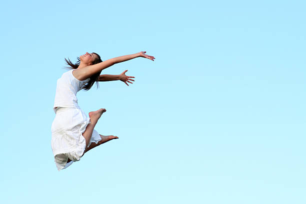 istock Woman jumping in white dress in sky 144321096