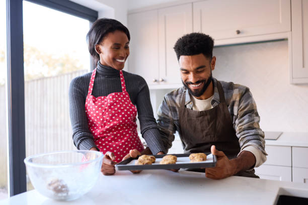 istock Couple At Home Baking Cookies Together In Kitchen 1443211072