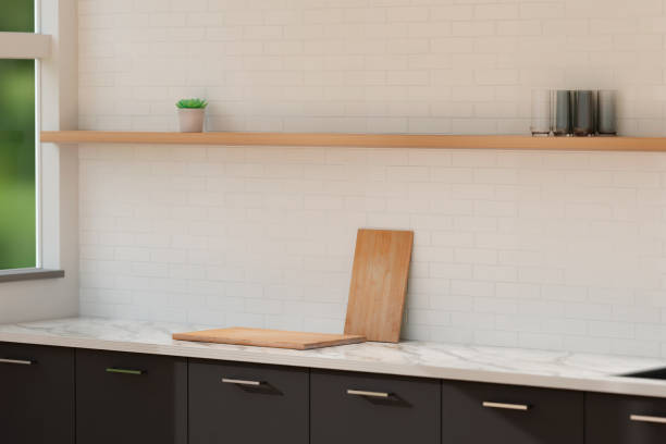 istock White and grey kitchen, white marble countertop with wooden cutting board. Grey cabinets, white tile. 1443211309