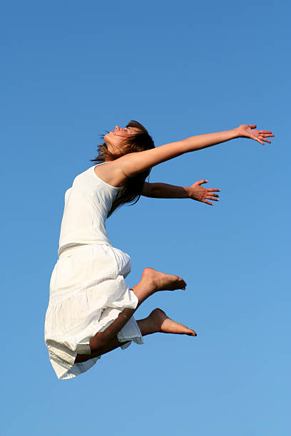 istock Woman jumping against blue sky 144321184