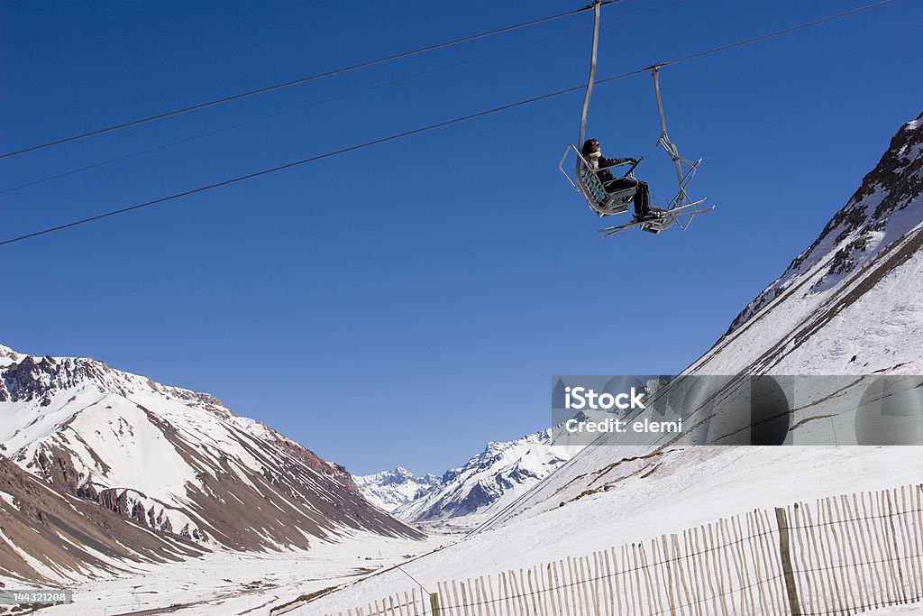 Ski lift in Penitentes resort on a sunny day Woman in a Ski lift in Penitentes, Mendoza, Argentina ski resort on a clear sunny day Mendoza Stock Photo