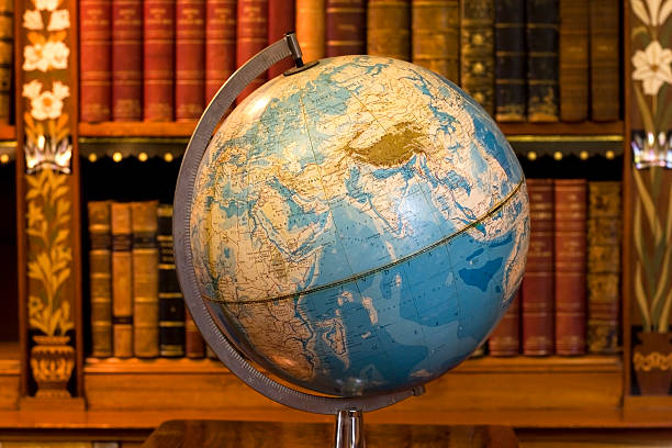 Globe in old library stock photo