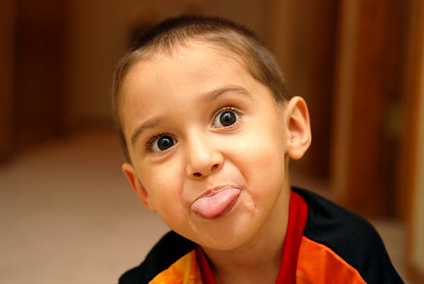 smorfie - toddler child animal tongue human tongue foto e immagini stock