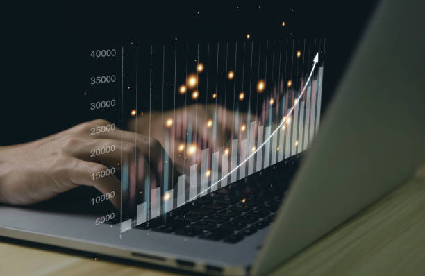 istock Businessman analyzing stock graph charts on laptop 1443215576