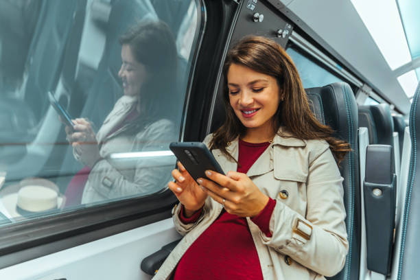 istock Smiling woman in the subway train texting 1443216565