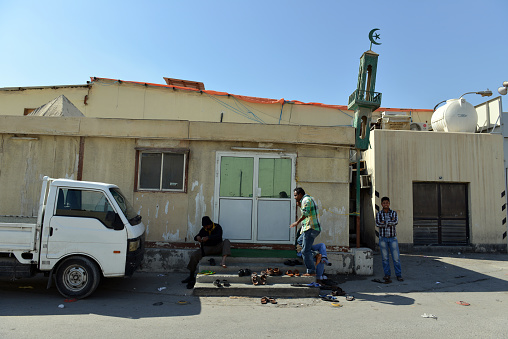 The iconic star and crescent symbol on top of a small mosque in downtown Doha, Qatar