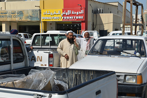 Parking lot of a small business area with shops that sells goods for home improvement in downtown Doha, Qatar