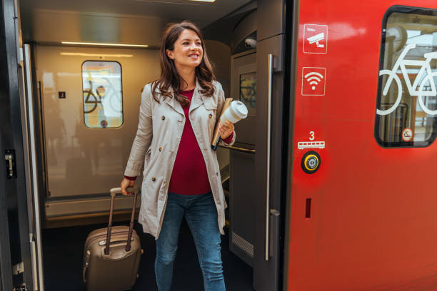 Woman passenger commuting train at station outdoor platform