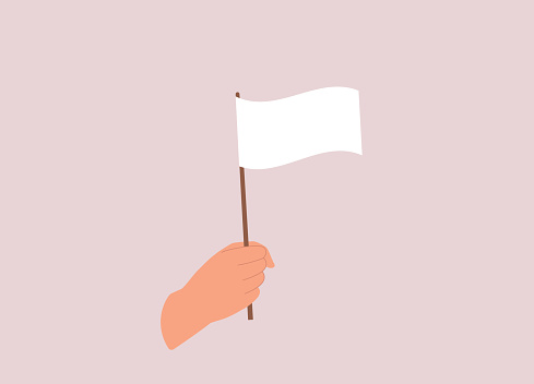 A Person’s Hand Holding A Small White Flag. Isolated On Color Background.