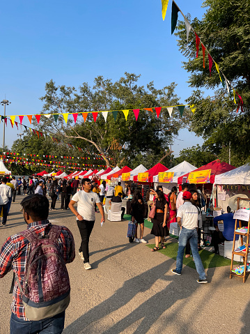 Horn Ok Please Food Festival, Delhi, India - November 11, 2022: Stock photo showing close-up view of groups of people wandering around exhibition grounds of Horn Ok Please Food Festival.