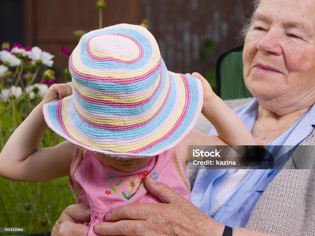 Wearing rainbow hat Grandmother look at Granddaughter when she wear her rainbow hat Active Seniors Stock Photo