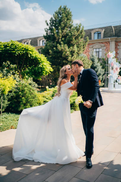 istock happy bride and groom dance in the park. 1443221221