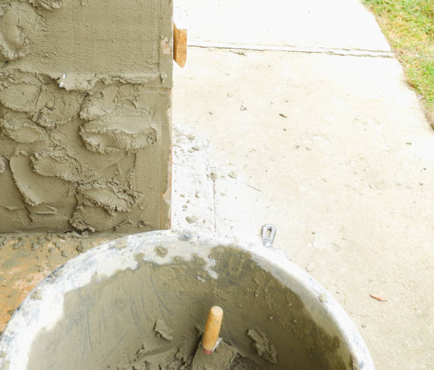 istock Cement plaster in a building container. The process of plastering a wall. Manually mixing cement mortar. 1443221559