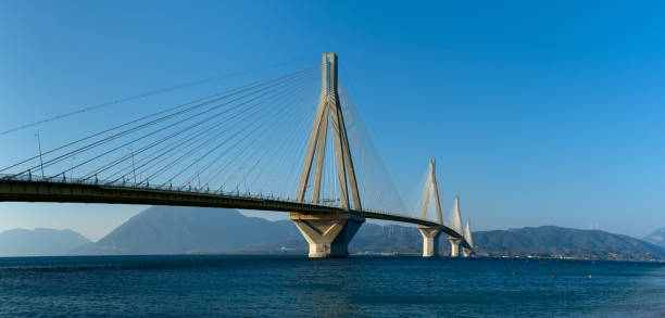 panorama landscape view of the landmark rio-antirio bridge across the gulf of corinth - gulf of corinth imagens e fotografias de stock