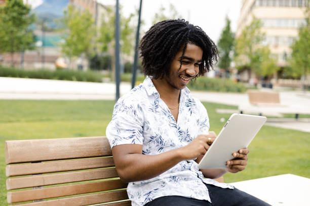 istock Young African American enjoying outdoors and using tablet 1443223185