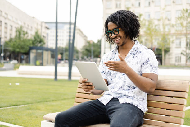 istock Young African American enjoying outdoors and talking online with someone 1443223188