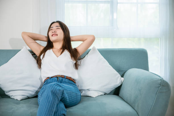 istock woman enjoying free time relaxing put arm hand back behind head 1443223640