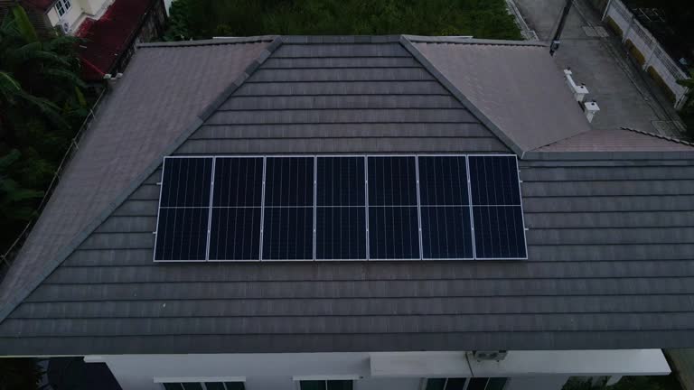 Aerial Shot Of Flying Over House With Solar Panels In sunset